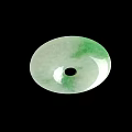Round Green And White Jade Pendant With Central Black Hole On Black Background