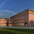 Modern Red Brick Office Building With Circular And Rectangular Design Front Lawn And Blue Sky