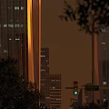 Modern Urban Office Building With Evening Lights Trees And Green Traffic Light