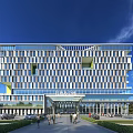 Modern Office Building With Glass Facade Grand Entrance And Pedestrians In Landscaped Area