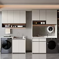 Modern Laundry Room Featuring Two Black Washing Machines White Cabinets And Gray Walls
