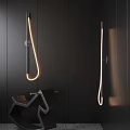 Modern Minimalist Wall Lights With Curved Design And Warm Glow On Dark Interior Wall