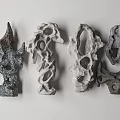Stone and Wood Abstract Sculptures with Intricate Holes and Textures Displayed on White Background