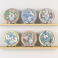 Colorful Cartoon Character Plates Displayed On Wooden Shelves With Various Designs