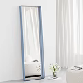 Stylish Blue Framed Mirror Reflecting White Curtains Sofa and Flowers