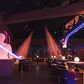 Modern Bar Interior with Neon Lights Sculpture Colorful Lighting and Seating Area
