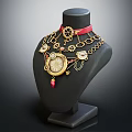 Elegant Gold Jewelry Set on Black Mannequin with Red Ribbon Decorative Pendants and Circular Chains
