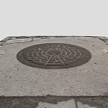 Urban Street Scene With Circular Manhole Cover On Cracked Stone Pavement