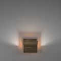 Modern Brass Wall Lamp Mounted On White Wall With Warm Light And Sleek Design