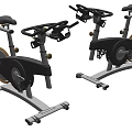 Two Stationary Exercise Bikes With Black And Silver Design For Home Gym Use