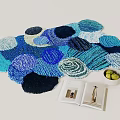 Vibrant Circular Patterned Rug With Open Book And Grapes Bowl On Light Floor