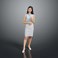 Woman standing in blue sleeveless top and white lace skirt holding cup against gray background
