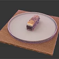 Layered Dessert On White Plate With Wooden Mat And Crunchy Topping