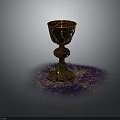 Golden Carved Cup With Purple And Golden Powder On Gray Background