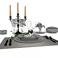 Elegant Dinnerware Set With Plates Cutlery Wine Glasses Candles And Flower Arrangement
