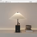 Modern Table Lamp With White Shade And Black Base On Table With Books And Bowl