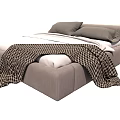 Modern Gray Upholstered Double Bed With Gray Pillows White Sheets And Plaid Blanket