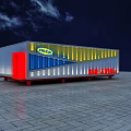 Modern Container Building With Yellow Blue Illuminated Exterior And Red Support Base