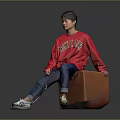 Man Wearing Red Love Me Sweater Sitting on Brown Trunk Blue Jeans White Sneakers