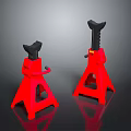 Pair Of Red Jack Stands With Black Top And Tripod Base On Dark Reflective Surface