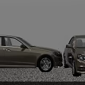 Two Beige And Silver Sedans Parked Front Facing Each Other On Pebble Ground