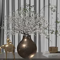 Copper Round Vase With White Floral Branches And Golden Horse Statue Beside Books And Candle