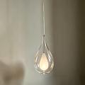 Transparent Glass Teardrop Pendant Light With Illuminated Bulb In Indoor Space