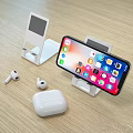 Smartphone On Charging Stand With Wireless Earbuds And Case On Wooden Table