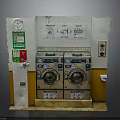 Laundry Room Interior With Twin Washing Machines Control Panel Wall Clock And Signs