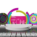 Vibrant Stage Design For EXPO 2024 With Colorful Rings Pink Backdrop And City Skyline