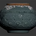 Blue Green Ceramic Jar With Carved Patterns And Lid Featuring Patterned Fabric Brown Trim 3d model