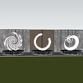 Three Metal Sculptures With Spiral And Circular Shapes In Garden Green Lawn And Wooden Gray Wall