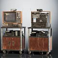 Two Vintage Televisions on Wooden Metal Cabinets with Wheels and Top Devices