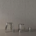 Stylish Modern Metal Stools With Various Sizes Arranged Against Concrete Wall Background