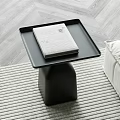 Modern Black Side Table with White Book on Tray Top Striped Rug and Light Sofa