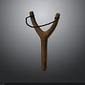 Wooden Y Shaped Slingshot With Black Rubber Band Isolated On Dark Background