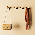 Round Top Metal Base Hooks On Wall With Beige Handbag And Brown Scarf