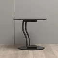 Modern Black Round Side Table With Curved Metal Legs On Wooden Floor