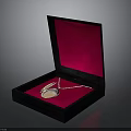 Open Black Jewelry Box With Red Velvet Interior Holding Silver Necklace And Pendant