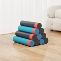 Stacked Blue Black And Red Exercise Mats On Wooden Floor In Living Room
