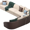 Modern Beige Sectional Sofa With Mixed Color Pillows And Cozy Green Throw Blanket