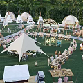 Scenic Camping Site With Green Grass Tents Outdoor Dining And Relaxation Spaces