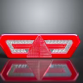 Red Rear Light With Triangle Design Reflective Surface And White Sections On Black Background