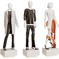 Fashion Mannequins Displaying Trendy Attire With Gray Coat Black Top Jeans And Orange Dress