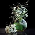 Green Glass Vase With White Small Flowers And Slender Branches On Black Background