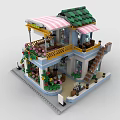 Two Story Brick Building With Green Roof Pink Striped Awning Balcony Tables Chairs And Flowers