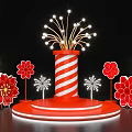 Art Installation Featuring Red And White Striped Cylinder With Firework Lights And Red Flower Decorations