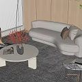 Modern Beige Curved Sofa And Round Marble Coffee Table Set With Decorative Vase On Rug