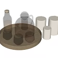 Glass cups displayed on wooden tray with candles and bottles in home decor setting