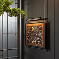 Modern Abstract Painting Hanging On Dark Wooden Wall With Green Pine Branch And Lighting Fixture